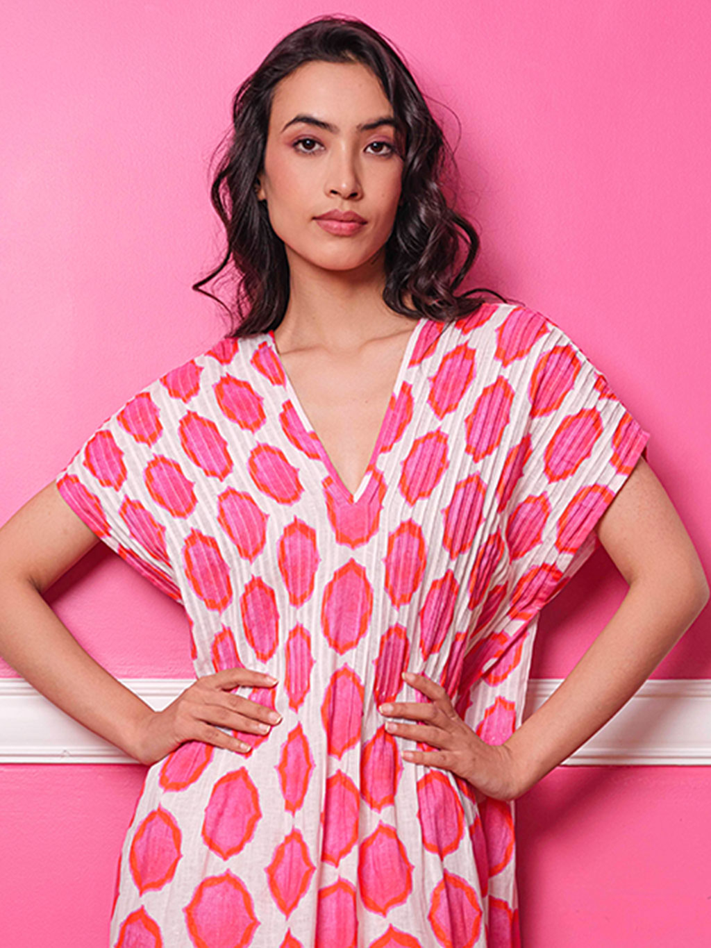 Detailed view of the sophisticated architectural pleating on pink ikat linen