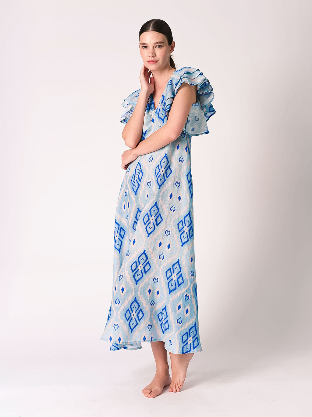 A luxury blue Ikat linen dress wit short ruffled sleeves for timeless statement summer style