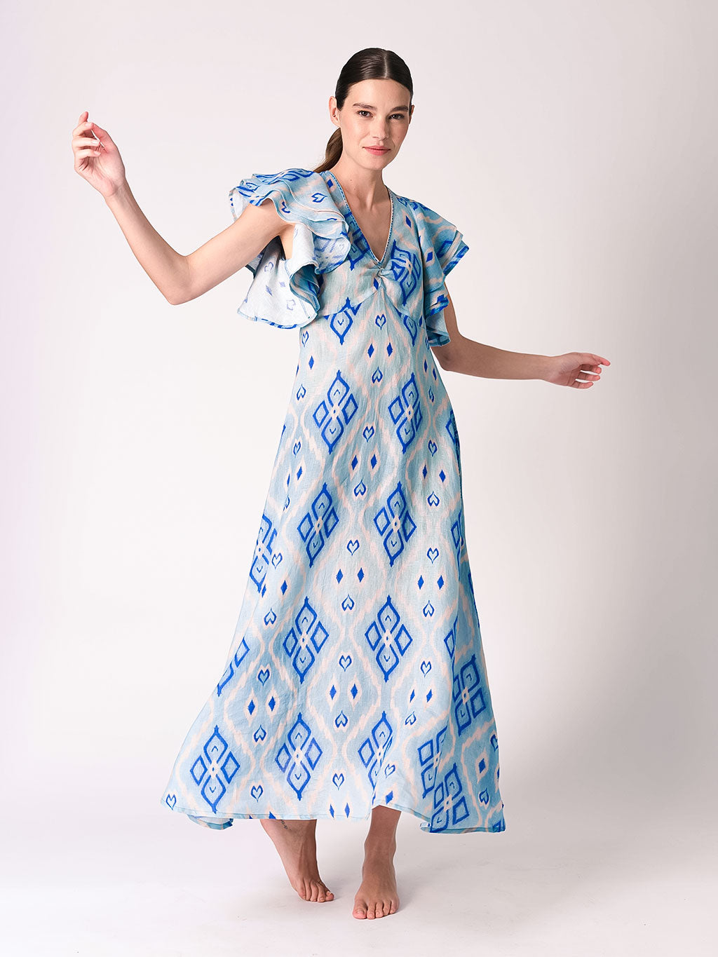 A blue and white Ikat patterned summer dress with statement ruffles