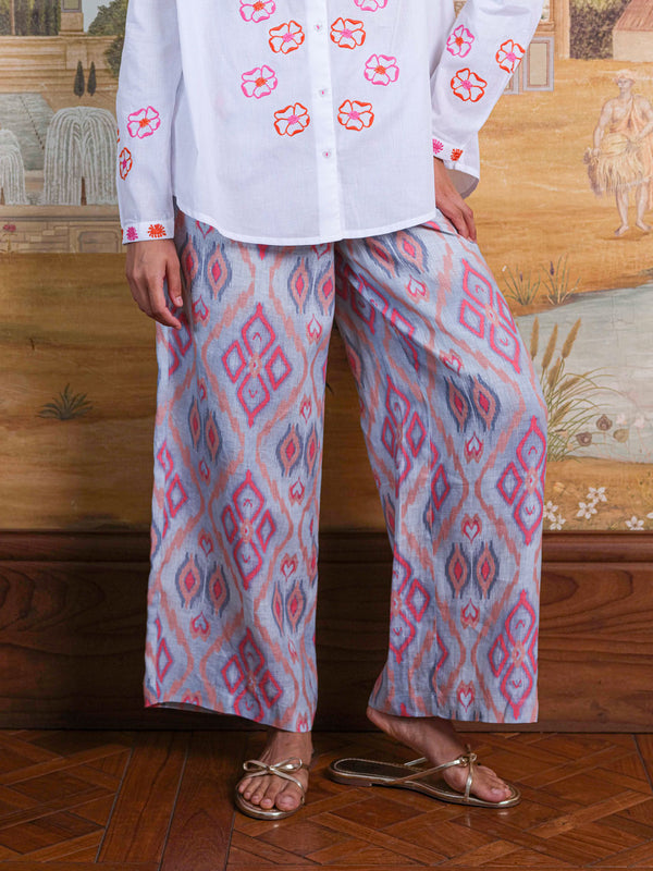 Detailed shot of the slightly cropped, wide-leg silhouette and the natural texture of the premium linen.