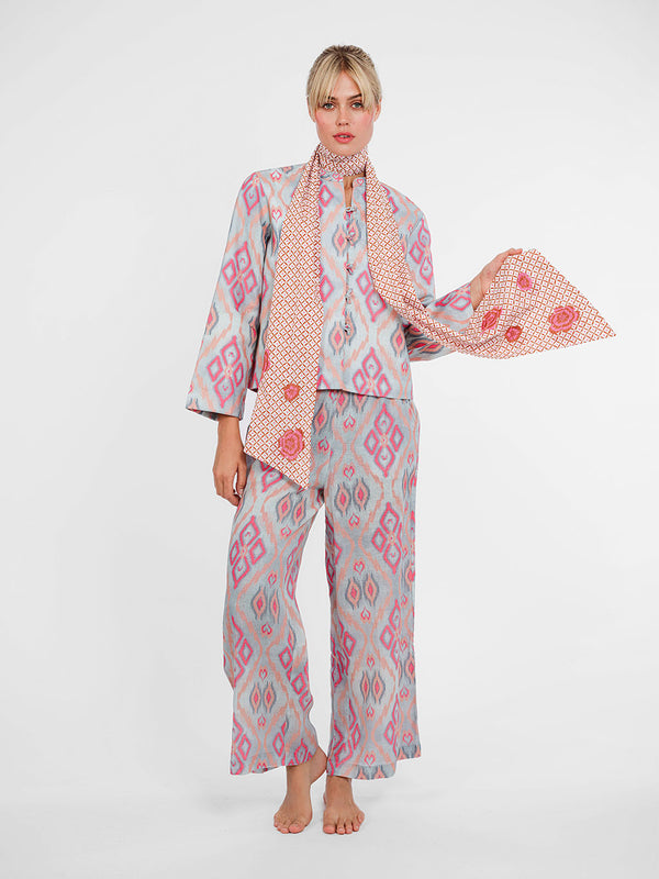 Model wearing the Fennel wide-leg linen pants in ikat pink sorbet, paired with the matching Comfrey jacket.