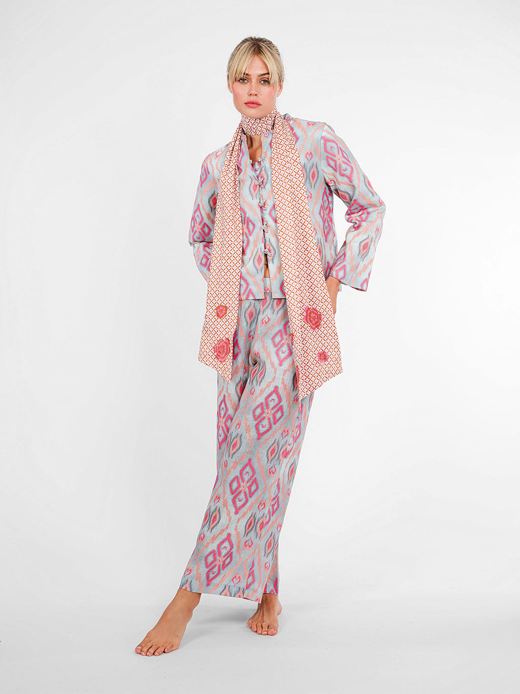 Model wearing the Fennel wide-leg linen pants in ikat pink sorbet, paired with the matching mandarin jacket and dotty mustard Scarf Belt