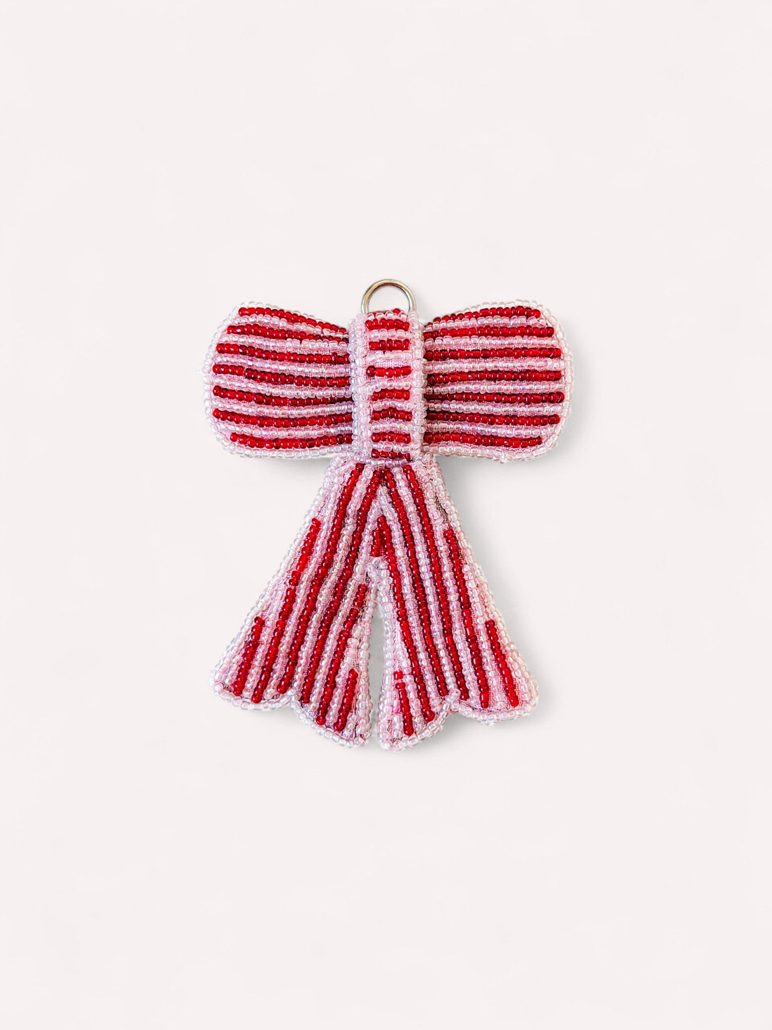 Decorative beaded bow Christmas ornament in red and pale pink stripes