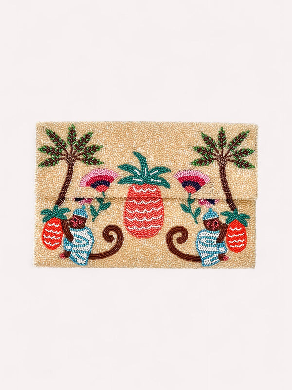 Nimo With Love sand-toned beaded envelope clutch with tropical monkey and pineapple motif, front view