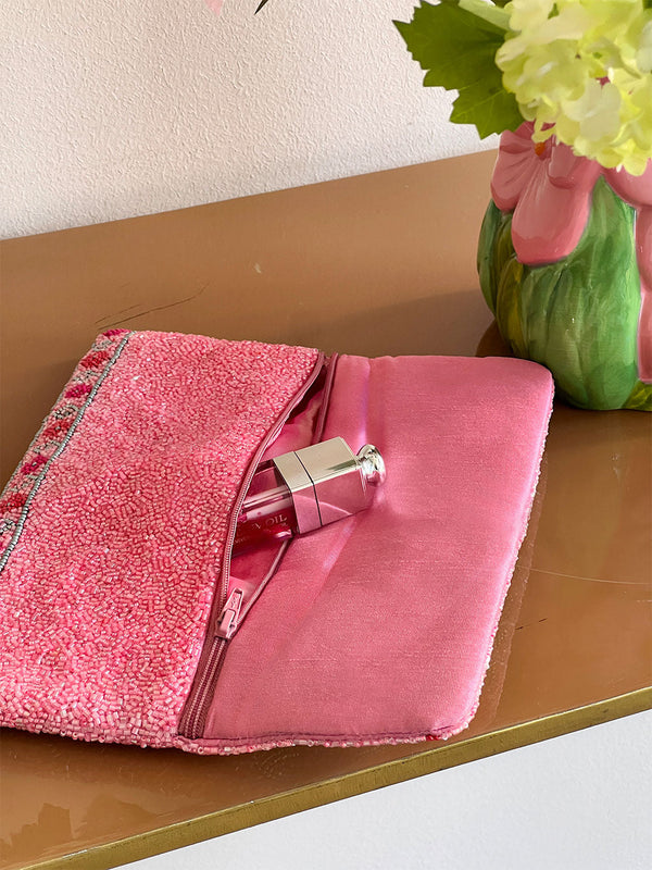 Interior view of Nimo with Love beaded clutch in pink with satin lining and zip pocket. Luxury handmade evening bag with magnetic closure.