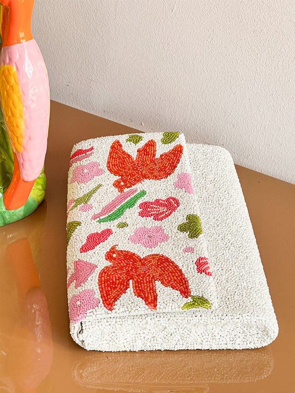 Envelope clutch with glass bead bird embroidery for elevated reosrt & summer looks, suitable for your next Portofino luxury stay.