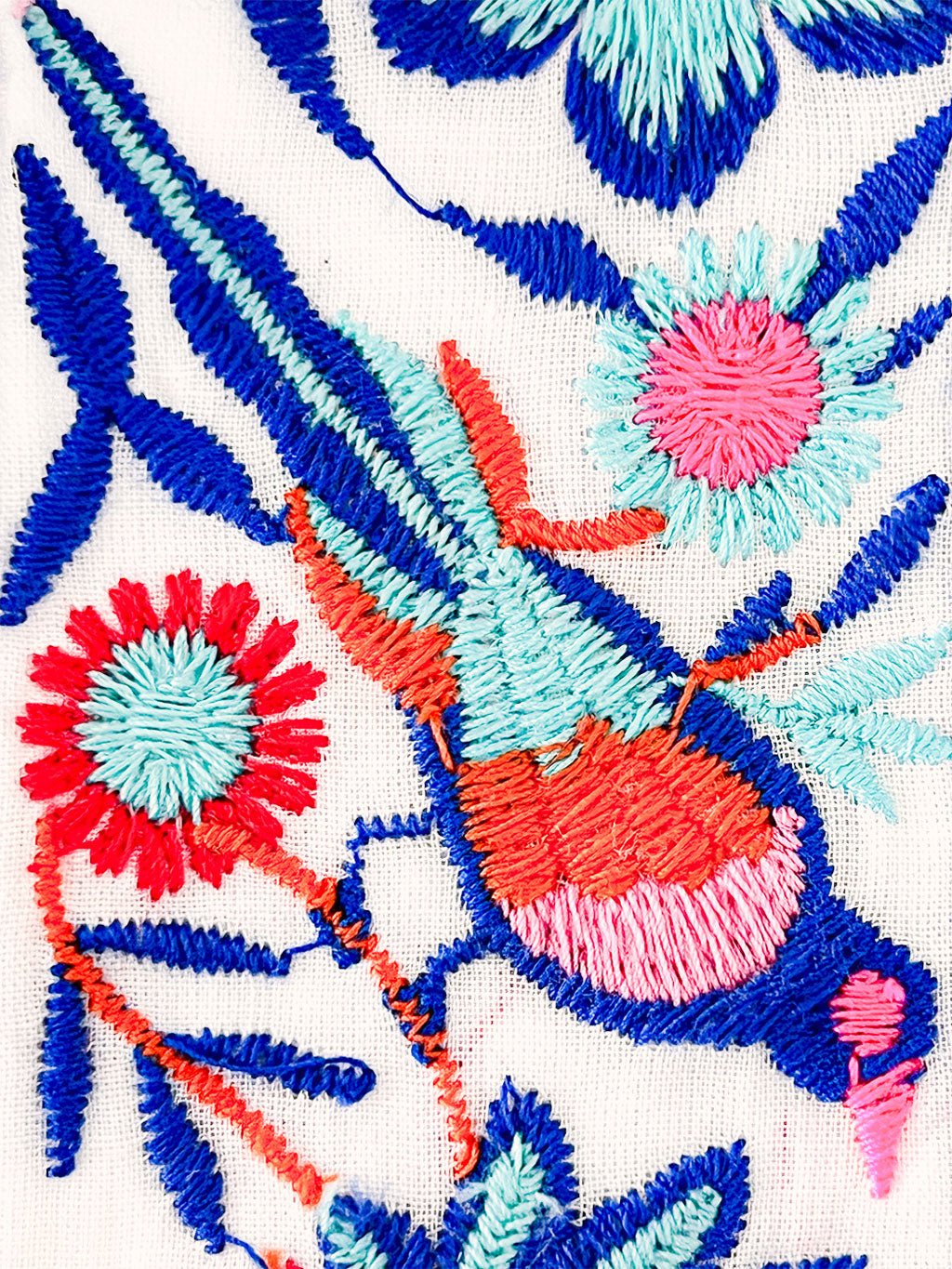 An embroidered self-tie fabric belt with a bohemian artisanal touch to accentuate the waist