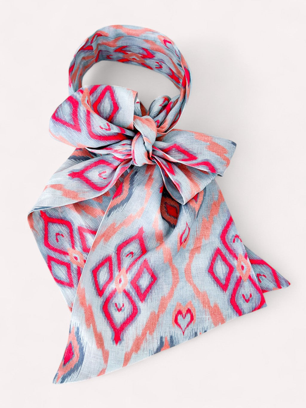 Close-up of the Nimo With Love Scarf Belt Ikat Sorbet showcasing the intricate sorbet-toned ikat pattern on textured linen.