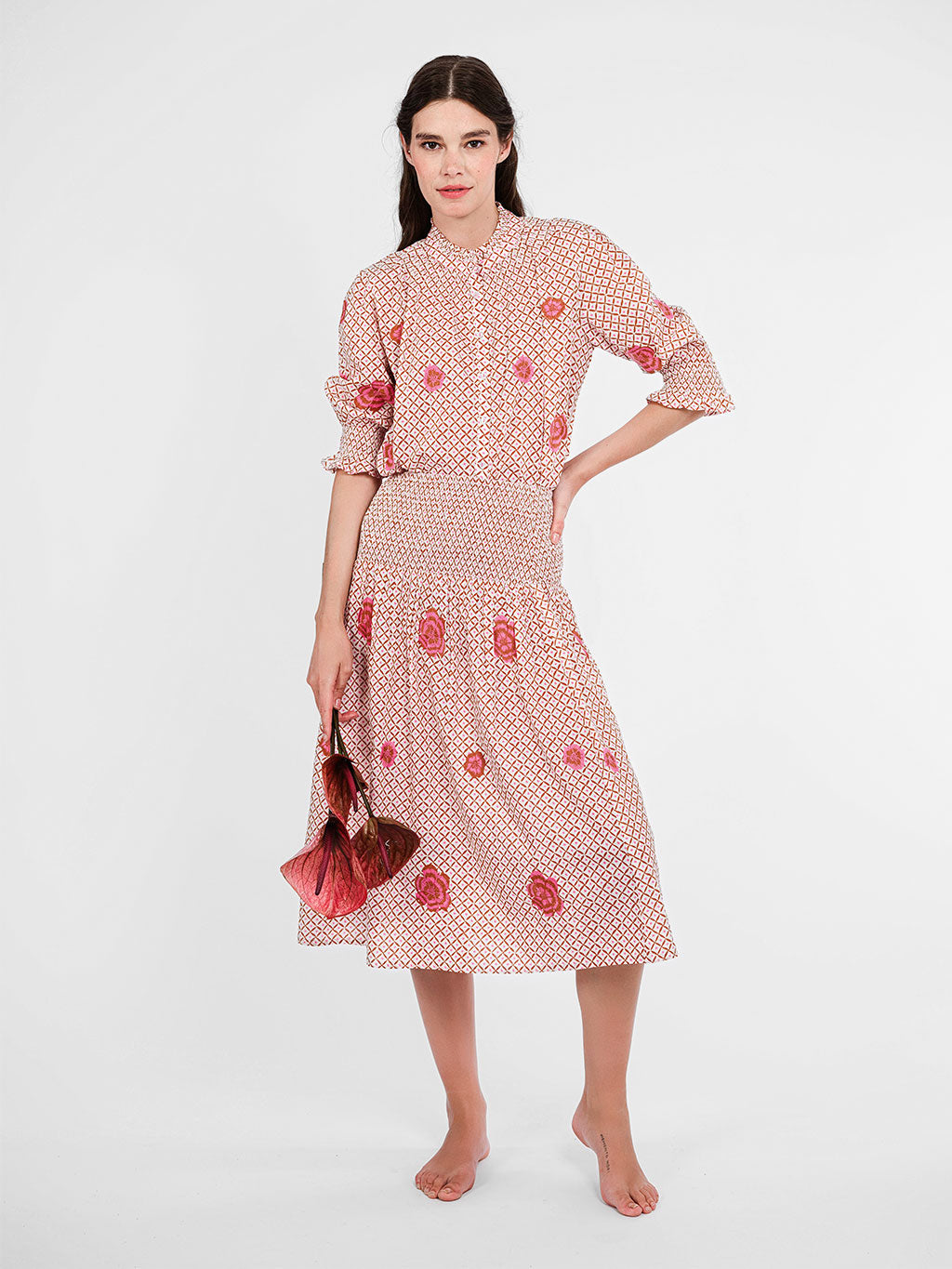 Knee-length Lads Love skirt by Nimo With Love in mustard dot-ikat organic cotton with pink floral embroidery.