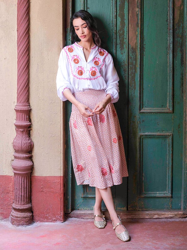 Model showcasing the comfortable fit and artisanal charm of the smocked Lads Love cotton skirt.