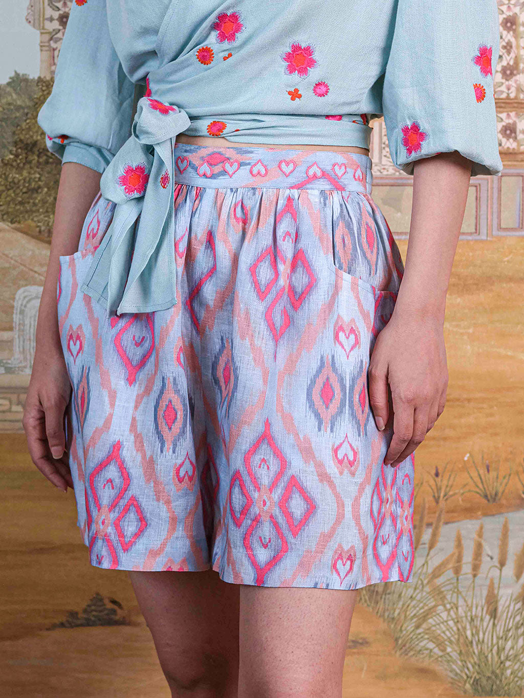 High-resolution shot of the contemporary grey and coral ikat design on the premium linen fabric.