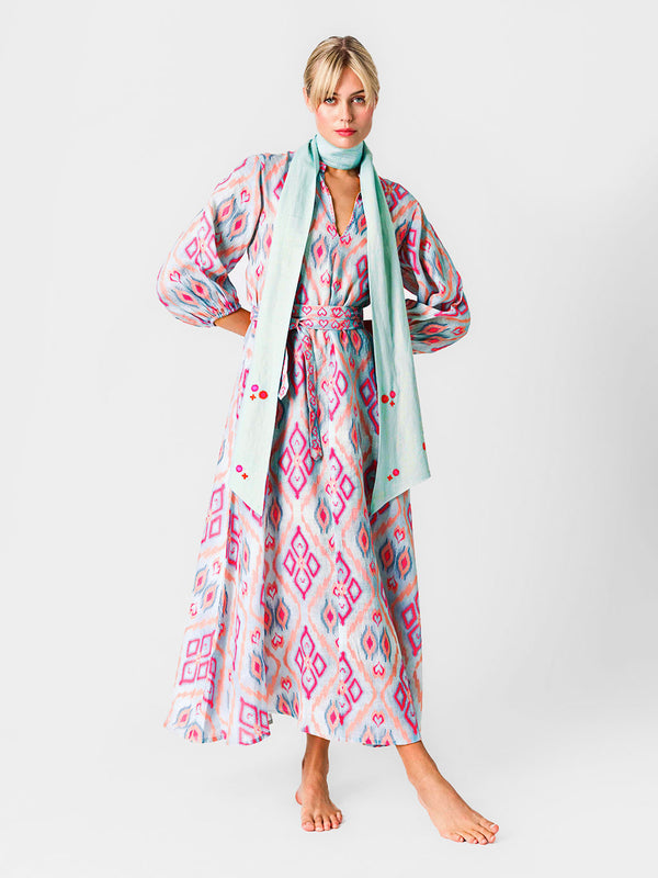 Model wearing the Marigold dress styled with the oversized Scarf Belt loosely slung around the neck