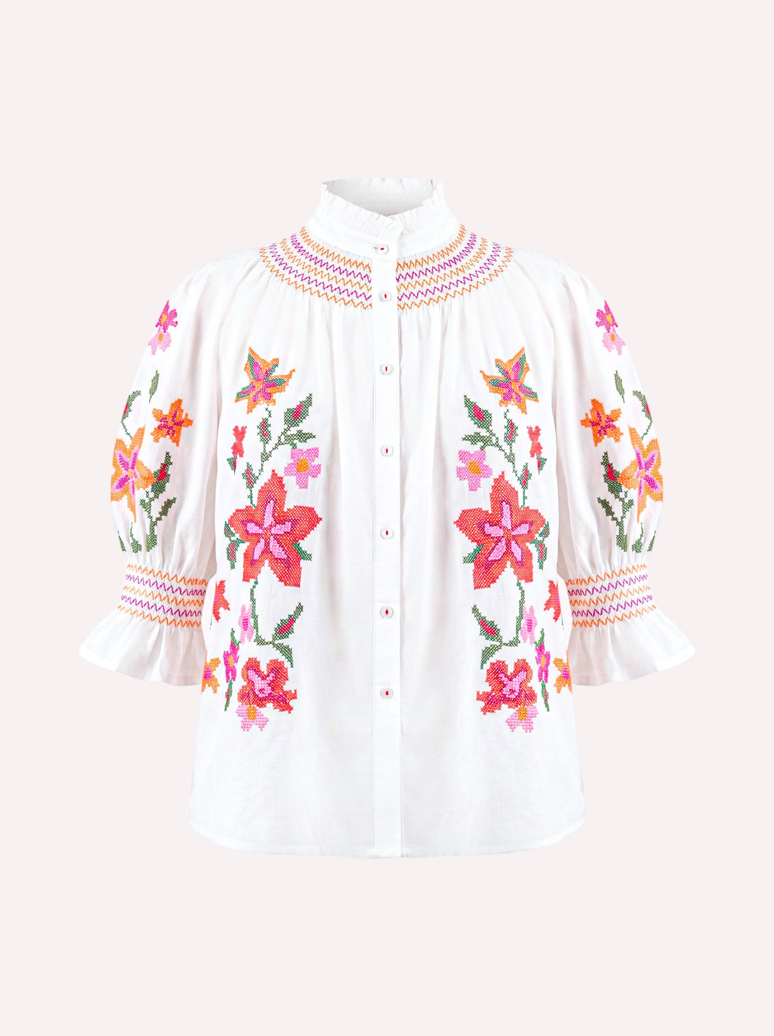 White organic cotton Nimo Bergamot Blouse with colorful floral cross-stitch embroidery.