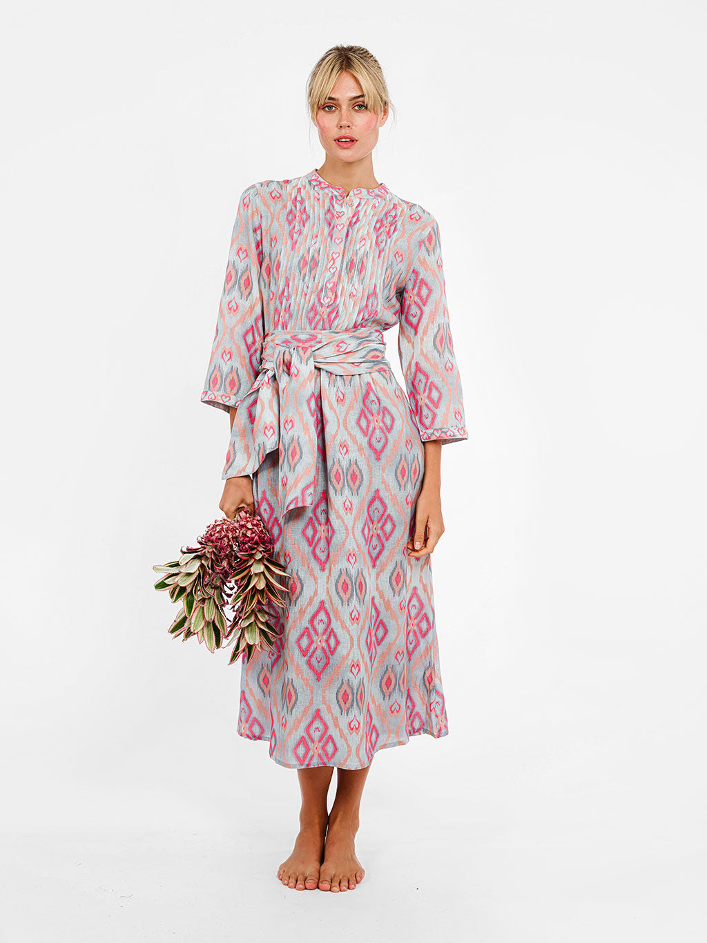 Model wearing the Woodruff dress styled with a cinched waist for a more defined, sophisticated resort silhouette.