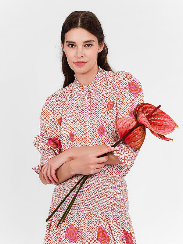 Detailed shot of the elegant smocked stand-up collar and button-down front of the Bergamot blouse.