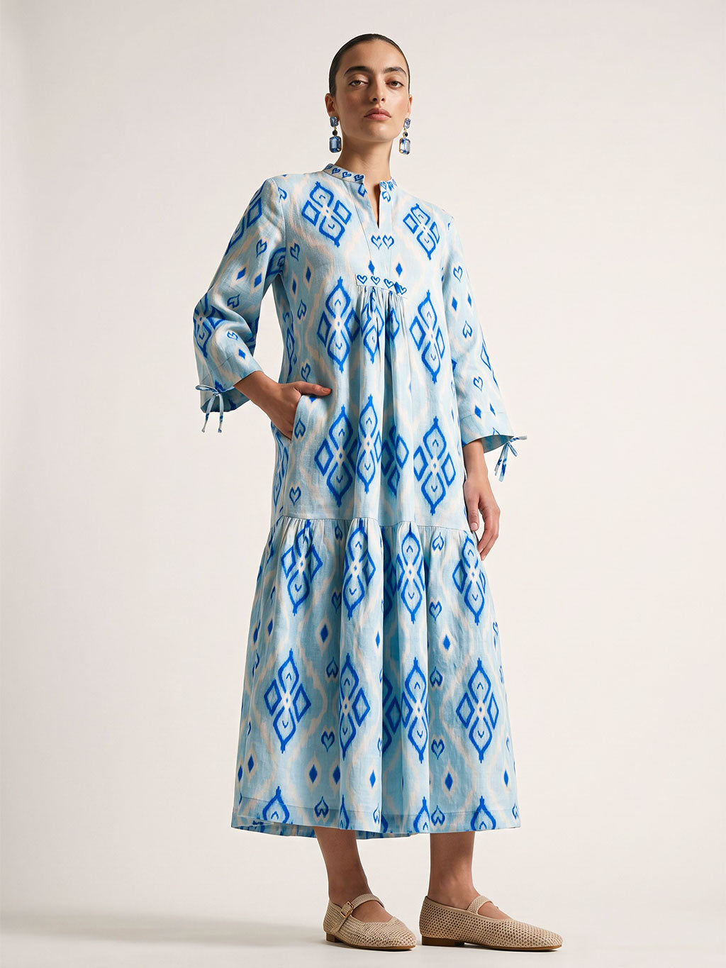 Light blue Nimo With Love Catmint linen midi dress with a geometric ikat pattern and three-quarter tie sleeves.
