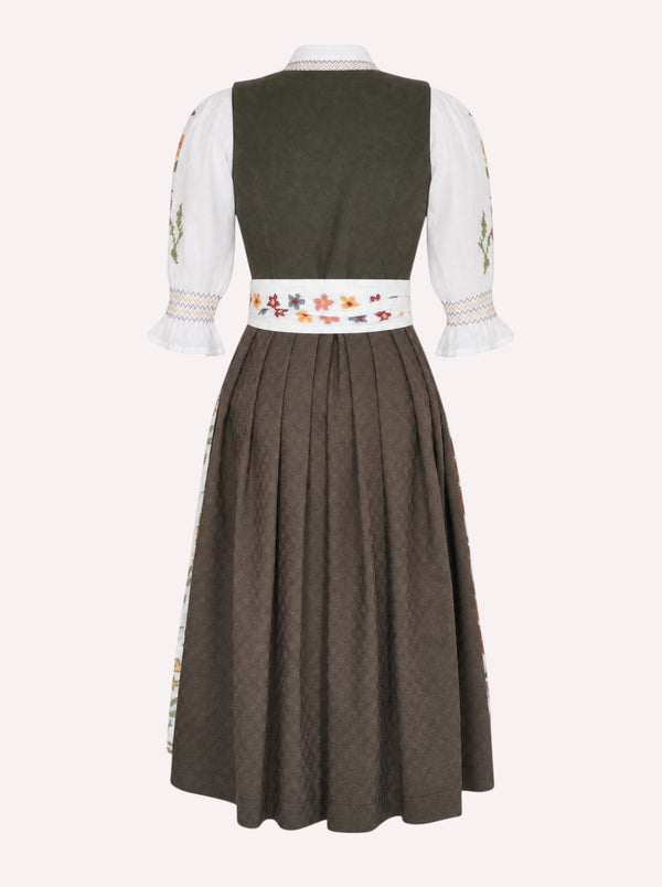 A traditional German dirndl dress shown from the back, featuring a dark olive green bodice, white sleeves with floral embroidery, and a pleated brown skirt with a decorative embroidered waistband.
