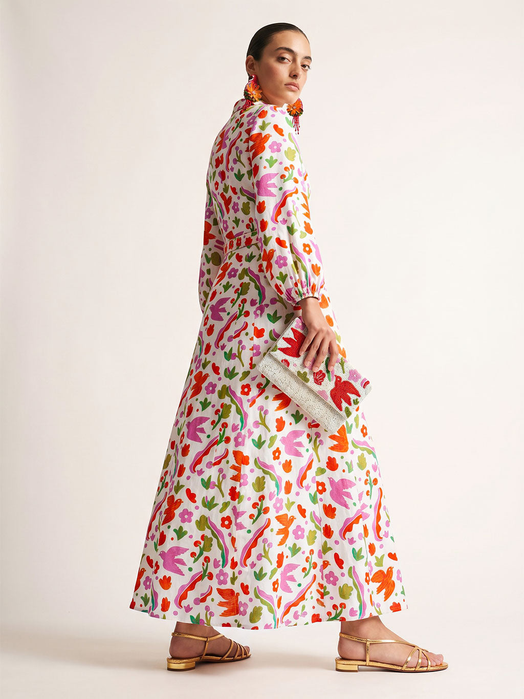 Side view of the ankle-length Marigold dress showcasing its fluid linen drape and hidden pocket design.