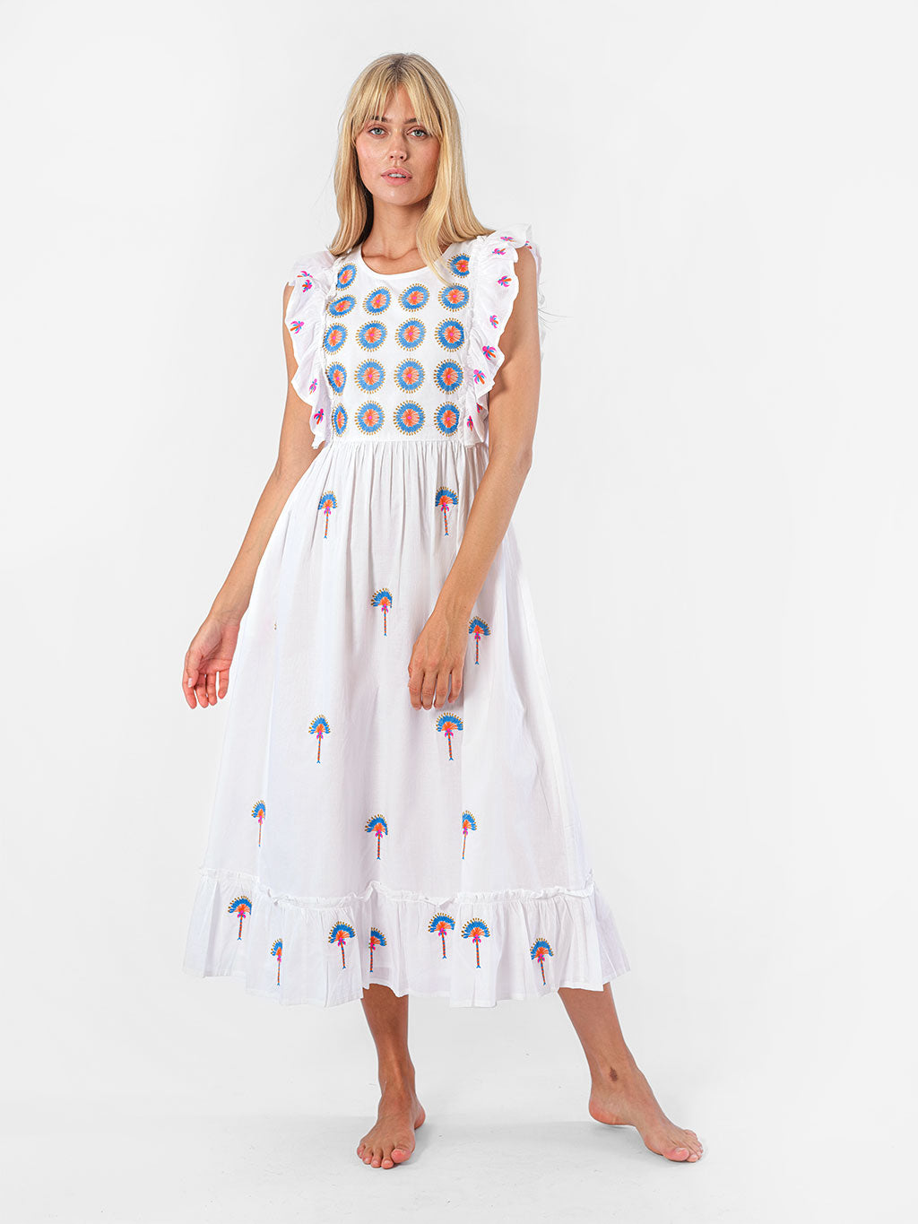 White organic cotton midi dress Pernilla by Nimo With Love featuring blue and coral sunburst embroidery and ruffled sleeves.