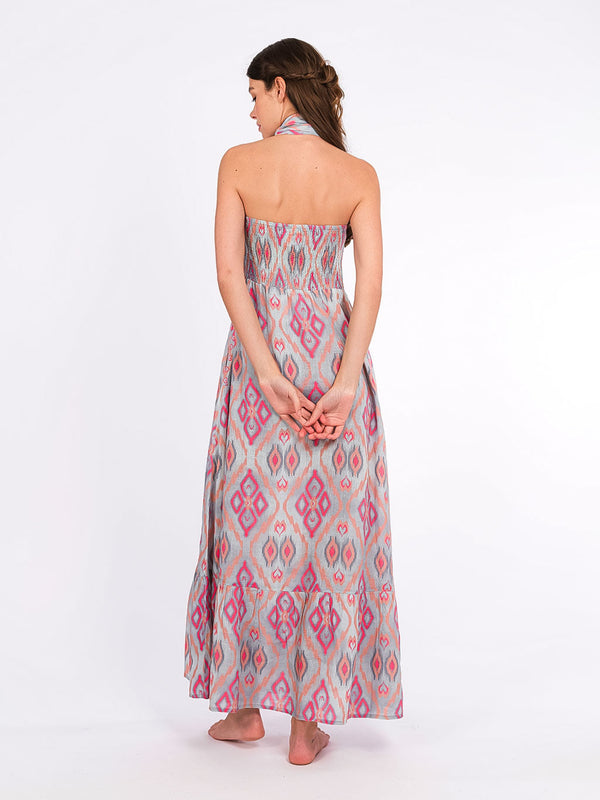 Rear view of the Caraway dress showcasing the flexible smocked back and the voluminous tiered skirt.