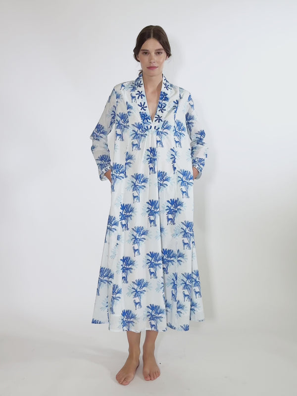 Video of the ankle-length Sandalwood dress by Nimo With Love in white organic cotton with a blue Zebra and palm print.
