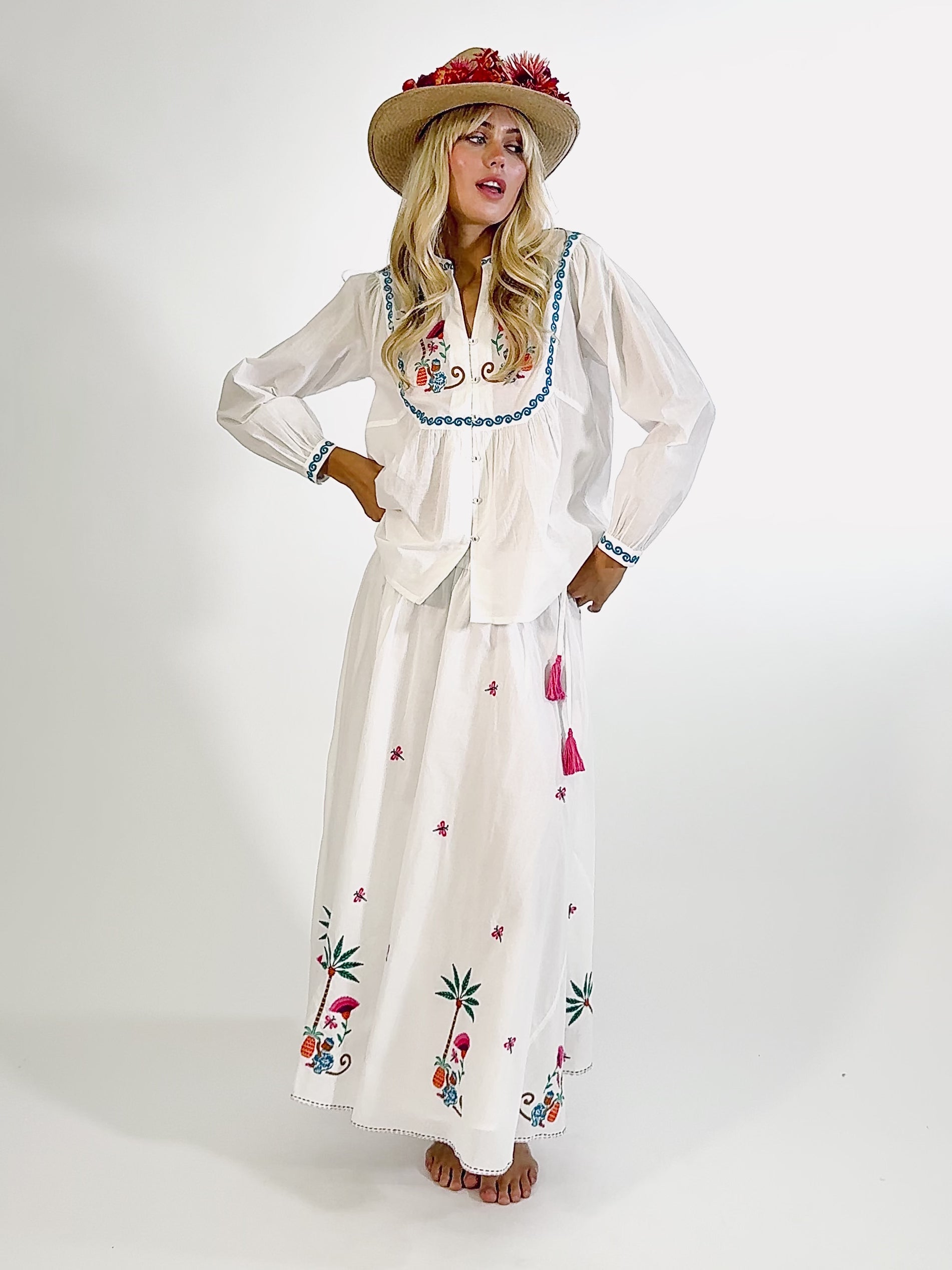 Video of elegant tropical summer look with embroidered monkey blouse and white skirt