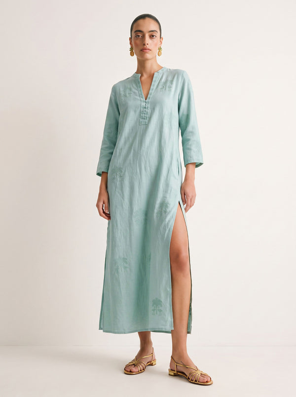 A woman modeling a light mint green maxi kurta with a high side slit, standing against a plain off-white studio background.