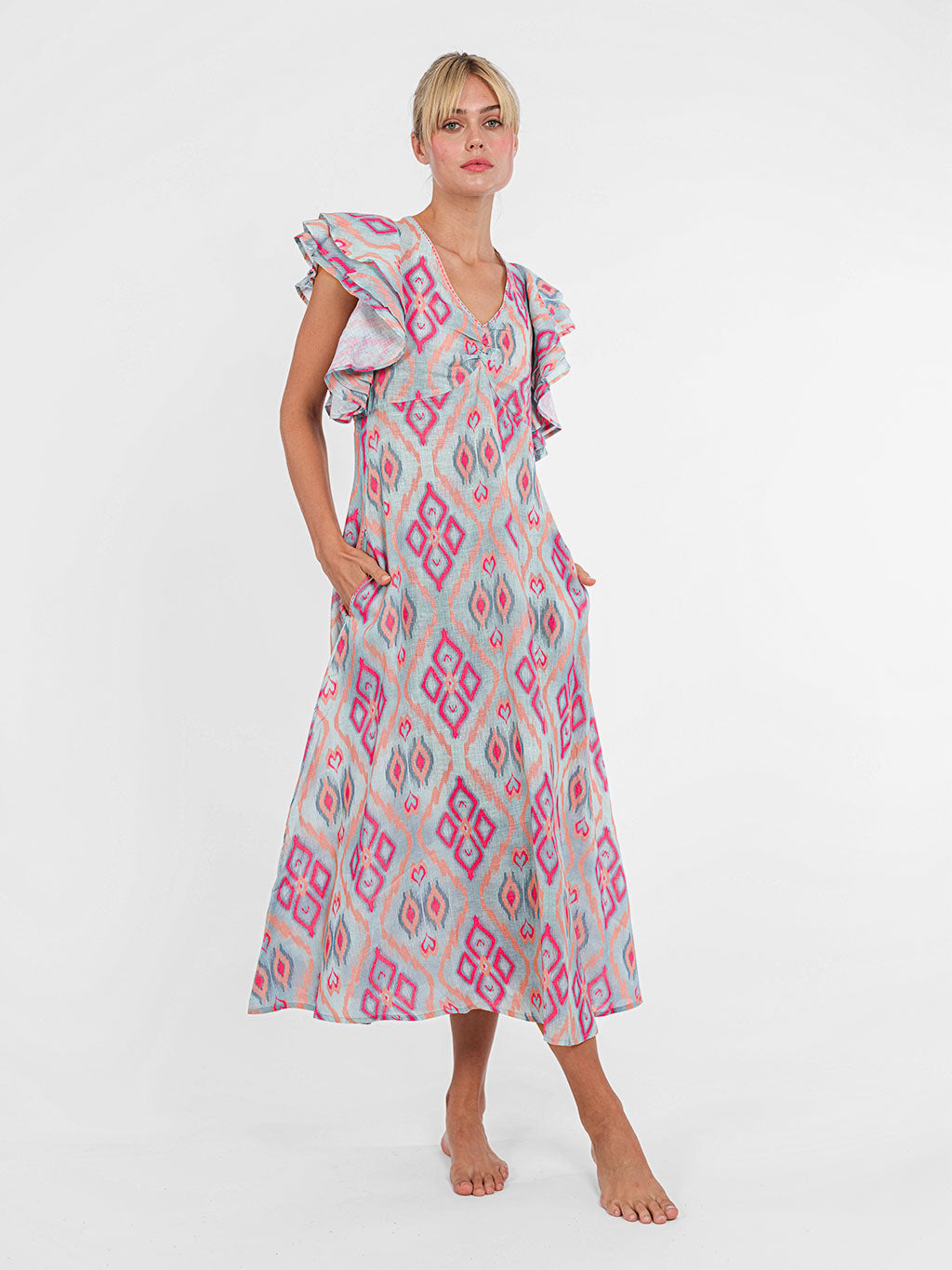 Midi-length Belladonna dress by Nimo With Love in grey and coral ikat linen with statement ruffle sleeves.
