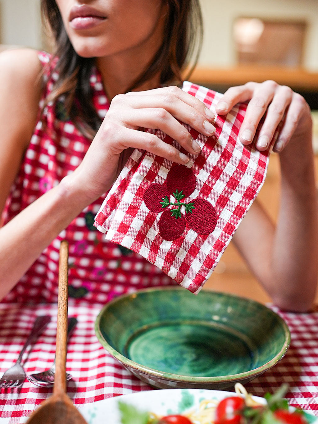 Close-up of a rustic GOTS-certified organic cotton napkin featuring detailed Mediterranean-inspired embroidery.