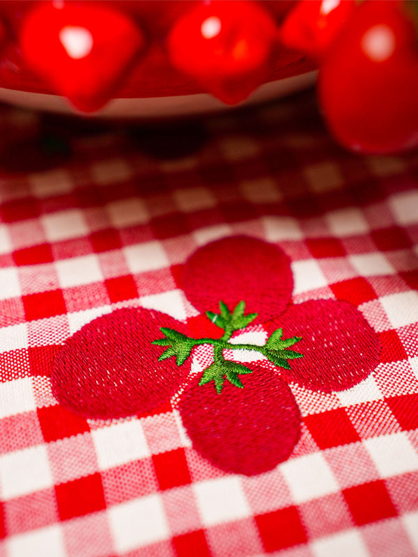 Sophisticated red gingham linen with detailed mediterranean motif embroidery for a charming home aesthetic.