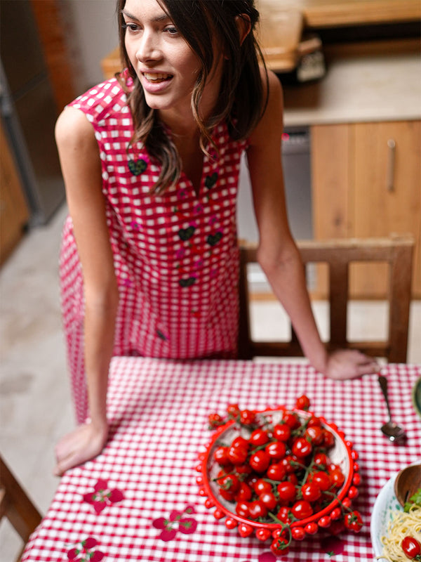 GOTS-certified organic cotton dress by Nimo featuring a vibrant trattoria-inspired check pattern and artisanal storytelling details.